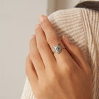 A hand adorned with the Pet Portrait Ring rests on a beige knit sweater, highlighting the elegance of this custom pet jewelry piece.