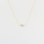 Opal Eye Necklace: Gold chain necklace with a small 925 sterling silver eye pendant set with turquoise and clear stones, shown on a white background.