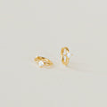 A pair of Athena Huggies crafted in gold and delicately accented with a sparkling diamond.