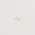 The Tiny Heart Studs in 18K Gold are a perfect gift, featuring delicate heart-shaped gold studs on a white surface—ideal for everyday wear.