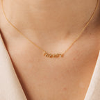 The Mrs. Necklace, crafted from 925 sterling silver in elegant cursive, is beautifully worn with light attire—a perfect wedding gift for her.
